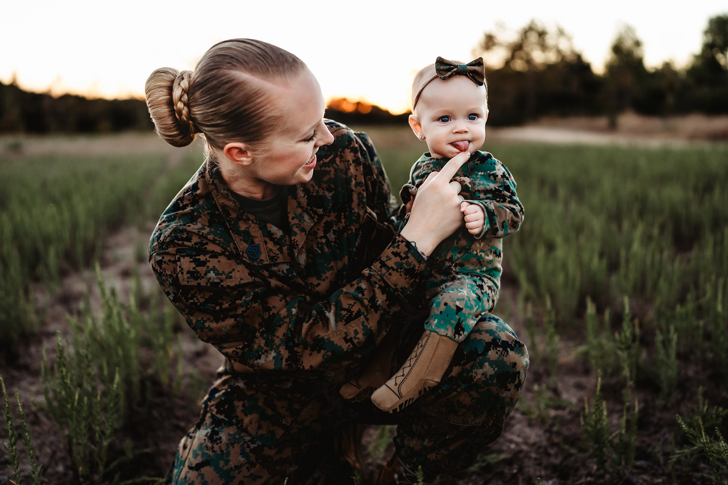 Marine Corp mom in uniform playing with her baby girl during a military family photo session in San Diego