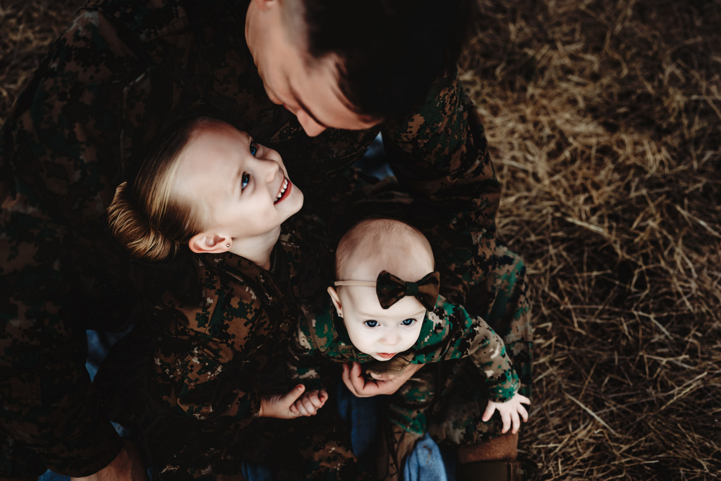 Marine Corp dad holding little girls during a military family photo session in San Diego