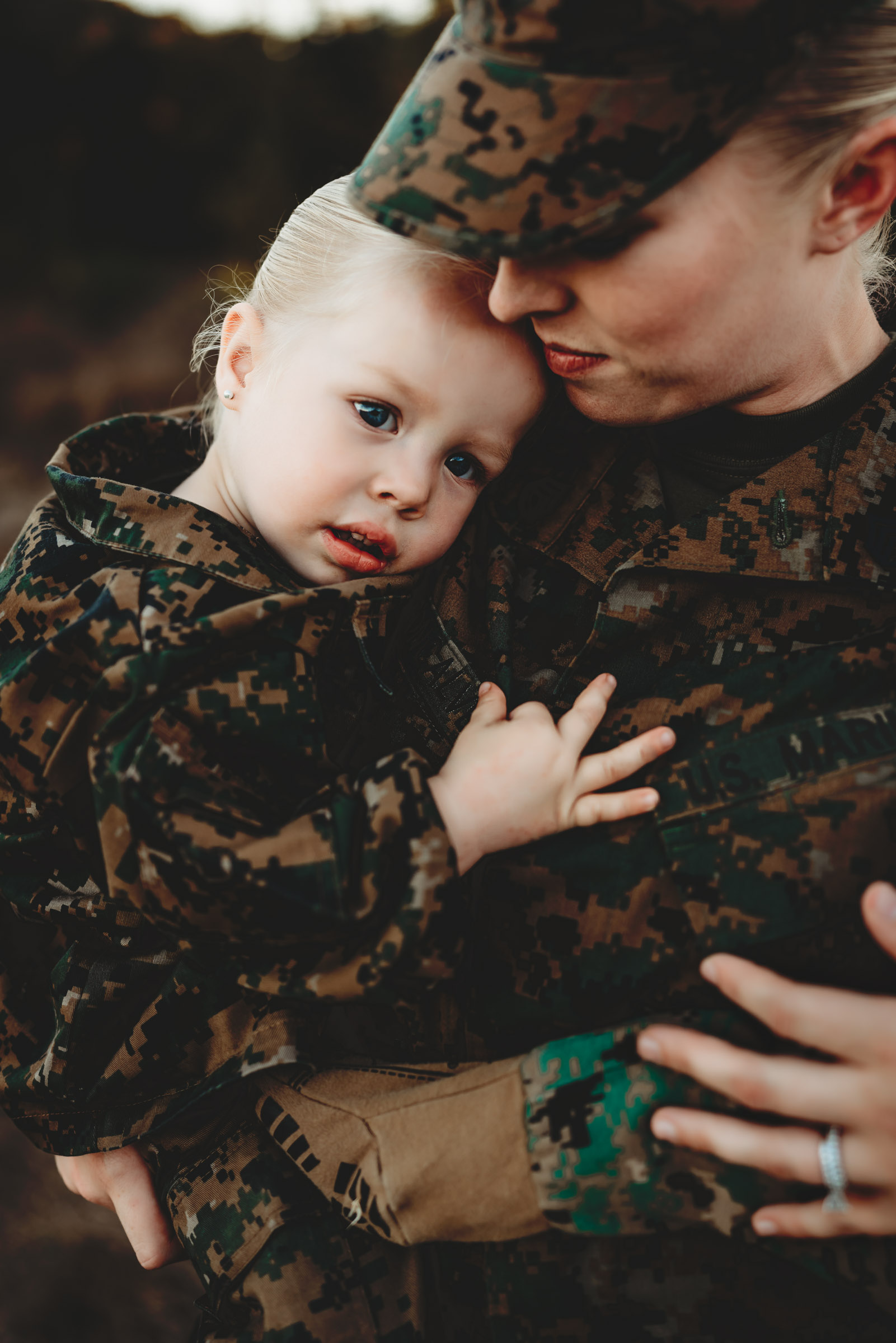 Marine Corp mom in uniform holding her little girl during a military family photo session in San Diego