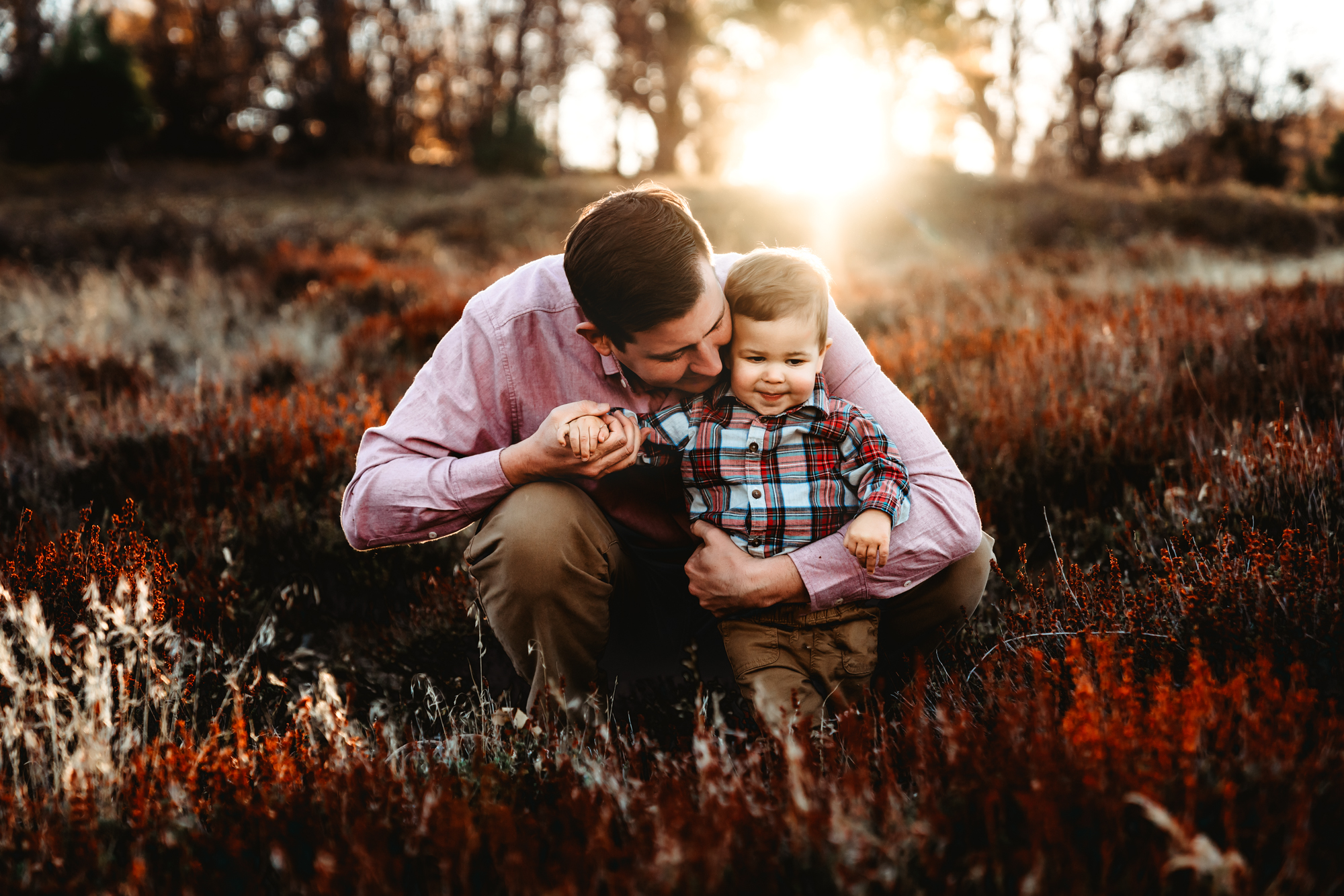 Dad and toddler son in a field in the Cuyamaca Mountains during a San Diego fall family photo session by Love Michelle Photography.