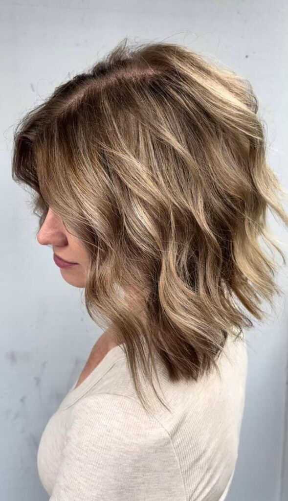 a woman in a cream short show's the back of her head in an article about a San Diego hair stylist who does cutting and highlighting.