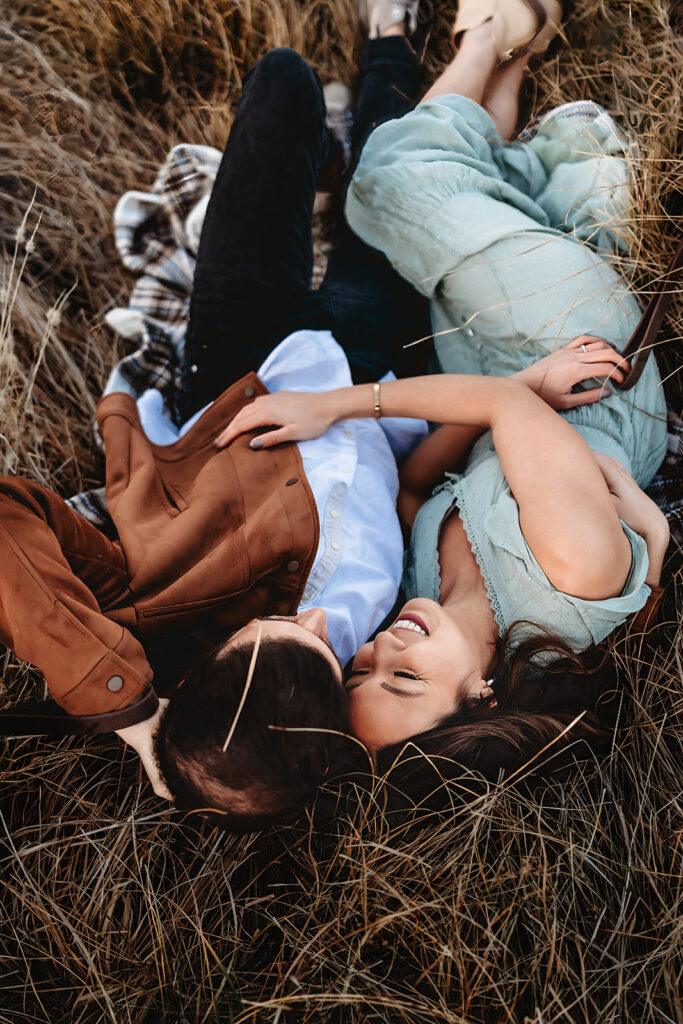 San Diego Family Photographer captures couple laying in the grass during outdoor family photos in San Diego