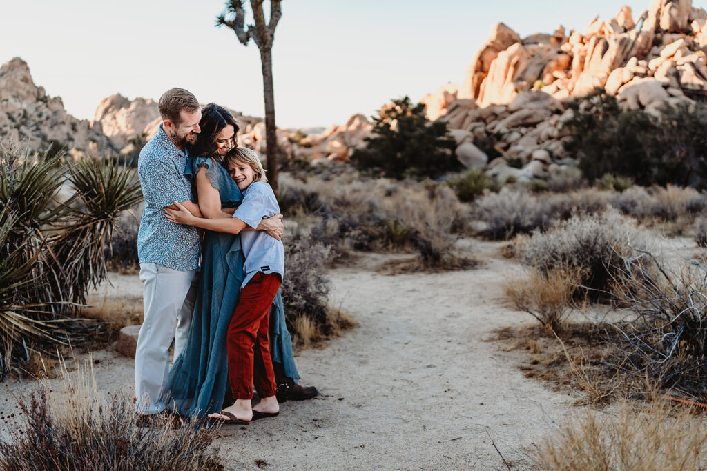 San Diego Family Photographer captures young boy hugging parents during outdoor family photos