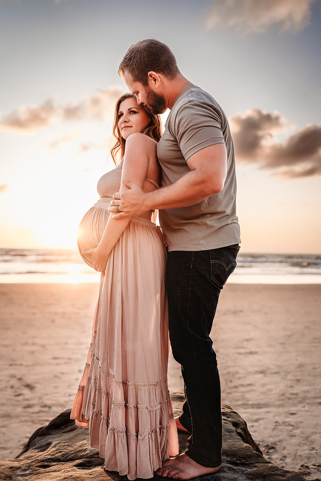 San Diego Maternity Photographer captures woman holding pregnant belly at sunset
