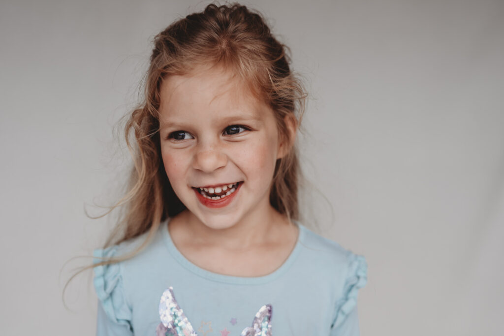 Little girl smiling during fine art school photos session | Love Michelle Photography