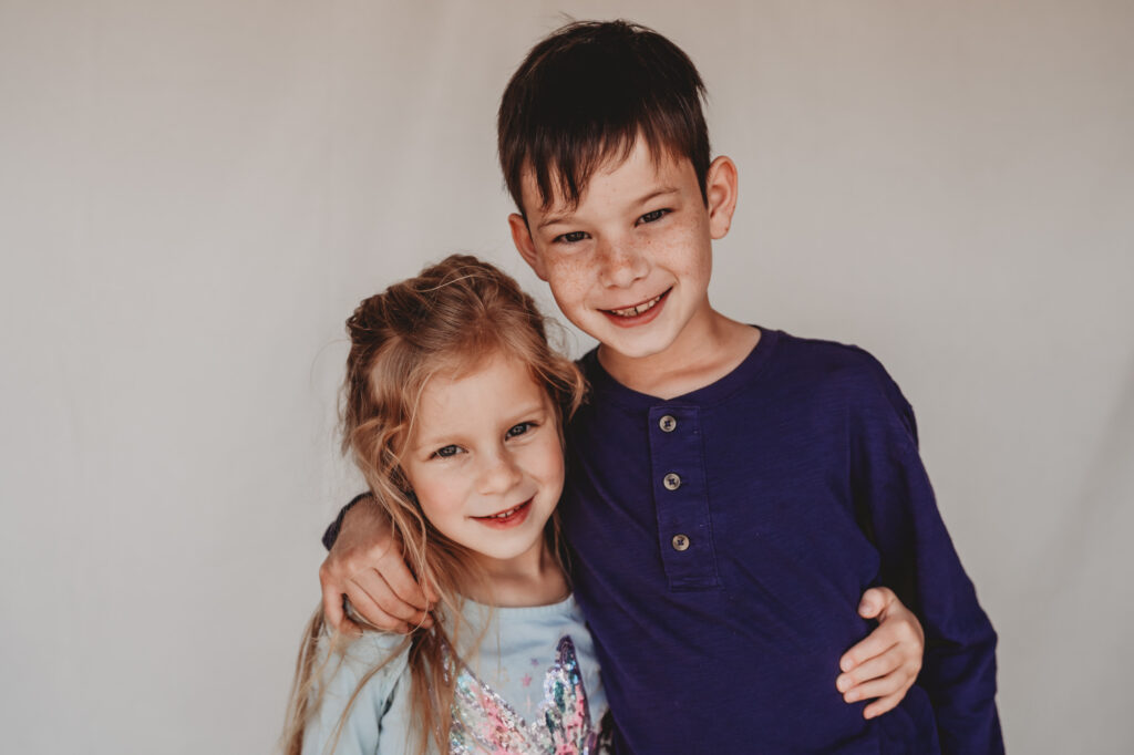 Siblings smiling during fine art school photography session | Love Michelle Photography