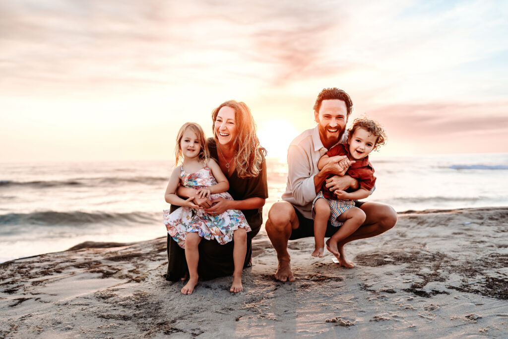 Love Michelle Photography | Family beach session with family crouched together