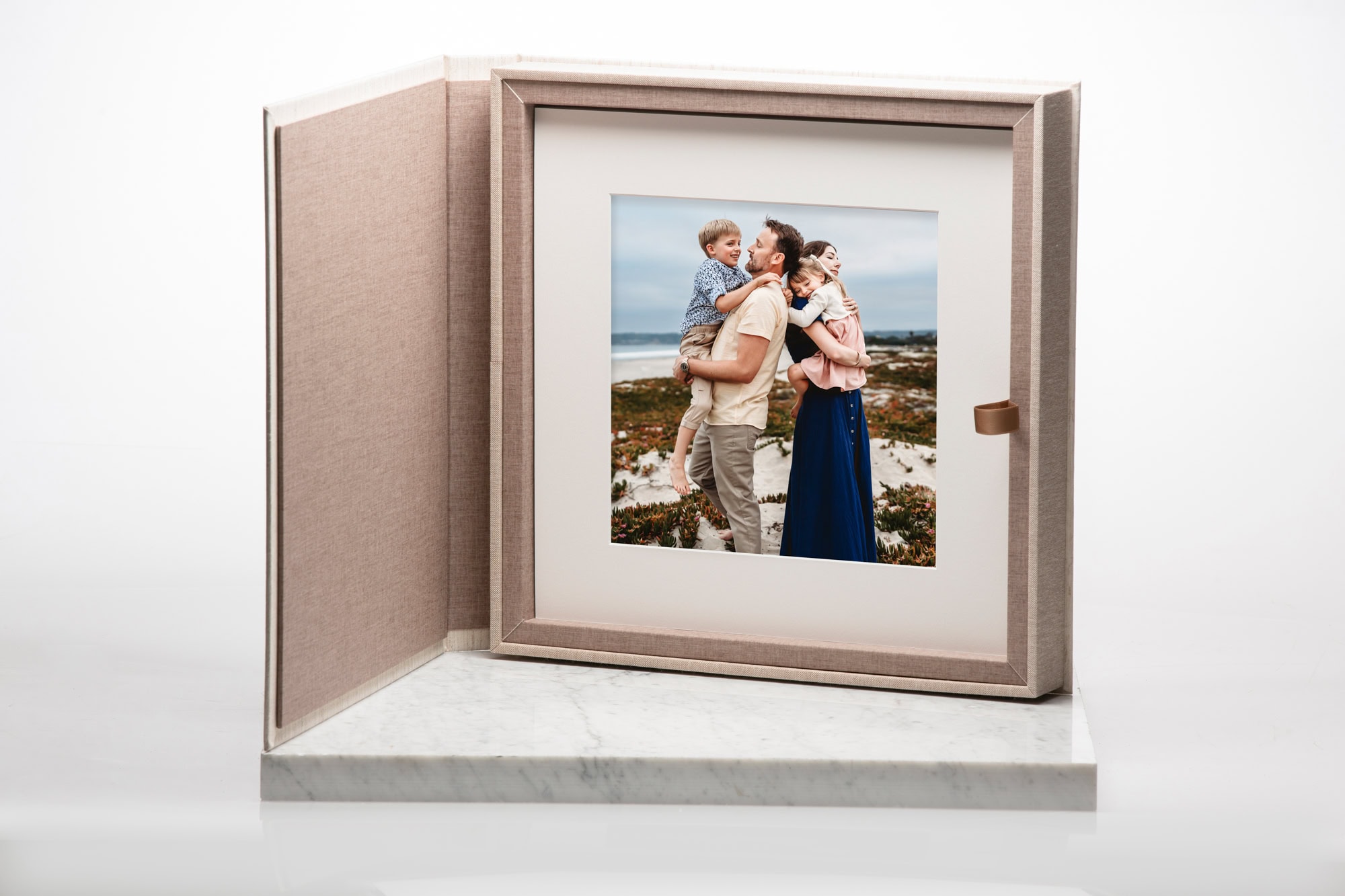 Linen folio box featuring a mounted family portrait taken on the beach by San Diego family photographer Love Michelle Photography, showcasing a premium printed artwork option.