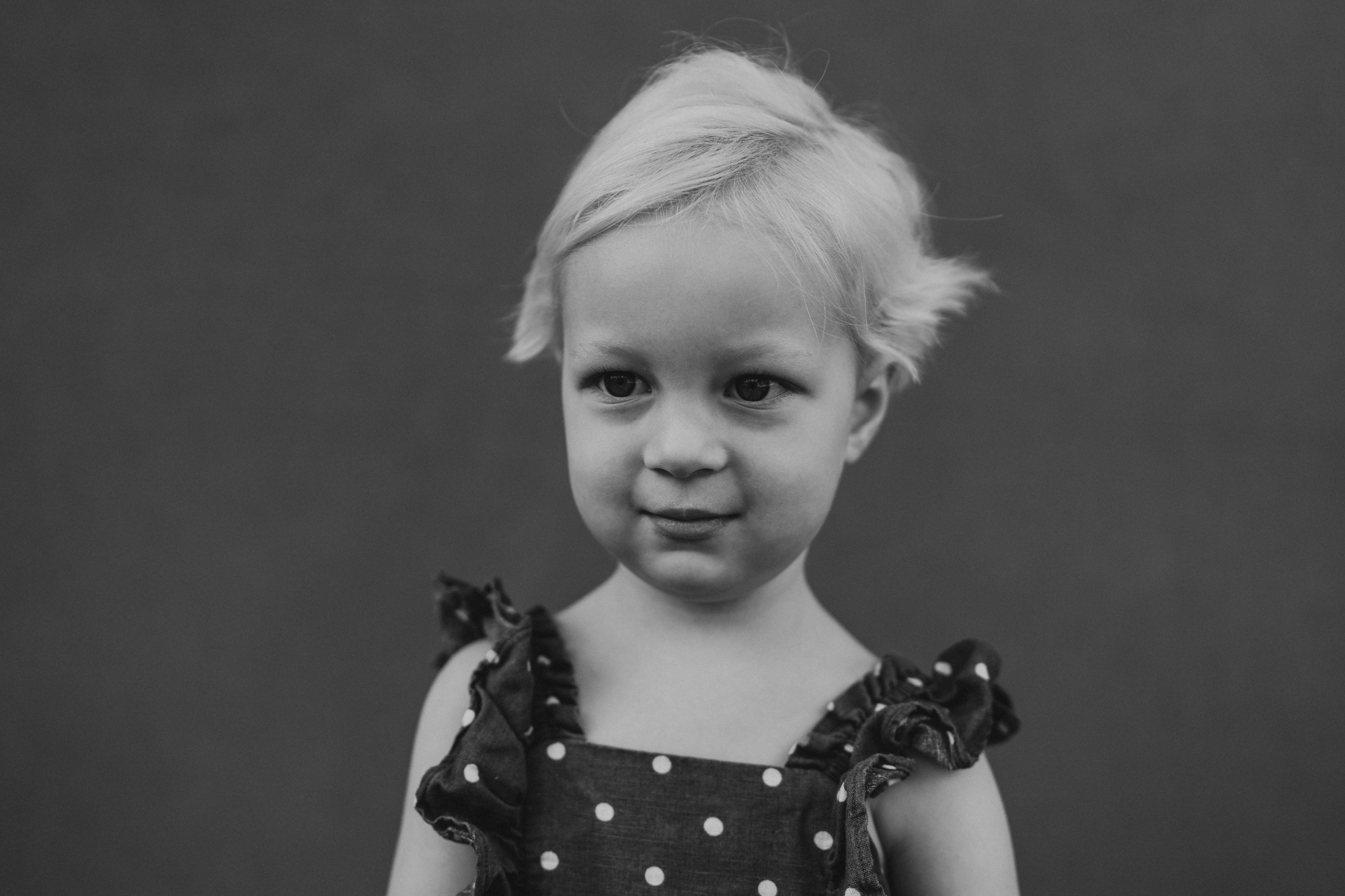 Black-and-white fine art preschool portrait of a toddler in a polka dot dress, San Diego preschool photographer Love Michelle Photography