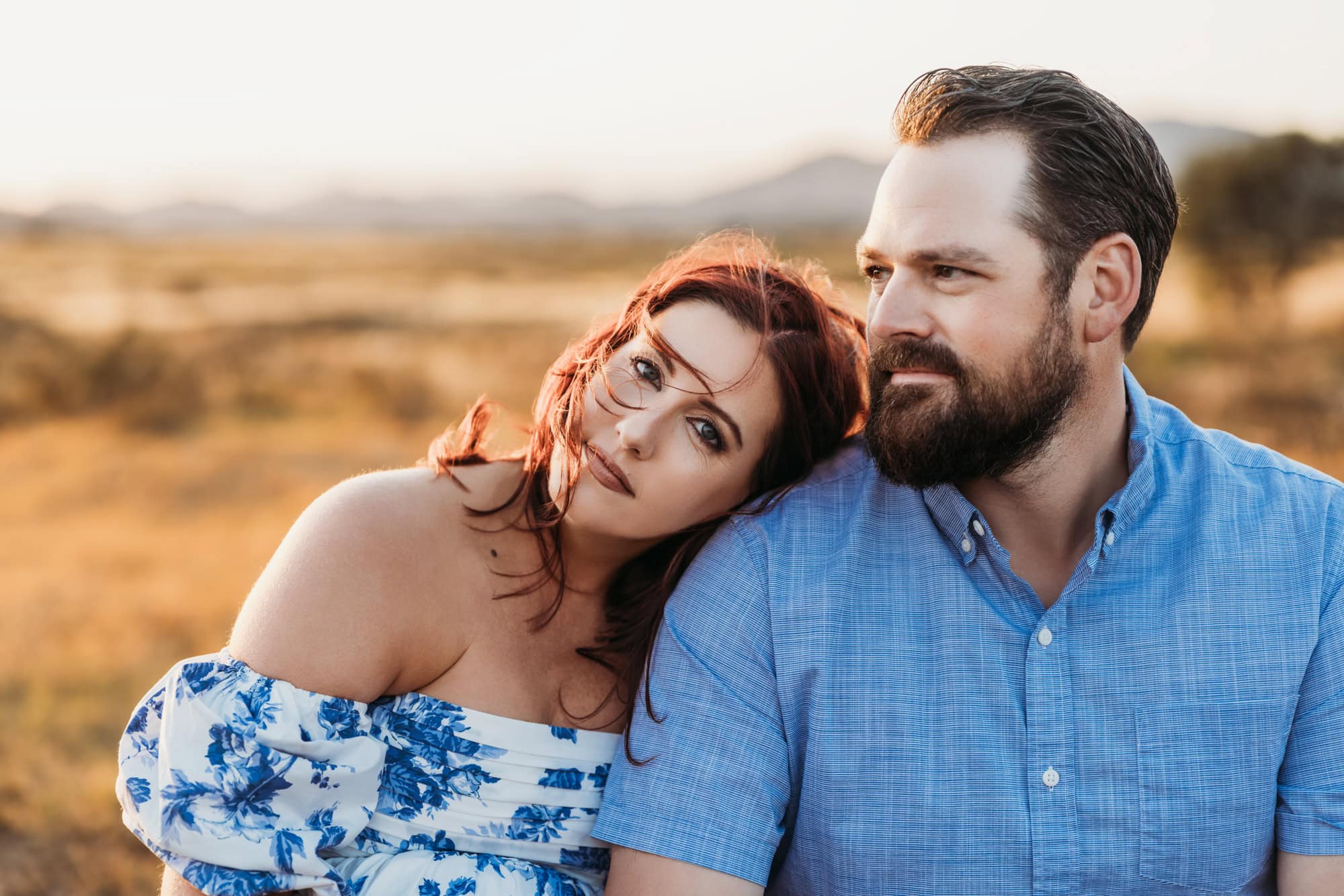 Romantic maternity portrait of expectant couple cuddling during golden hour in San Diego